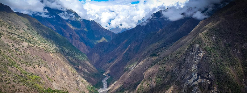 Hiker enjoying panoramic view of Waqrapukara and Apurimac canyon
